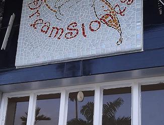 Store front mosaic sign on concrete base