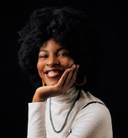 Alexandra Stewart Smiling in right at you in a white turtleneck sweater.