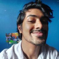 Smiling image of artist with blue background