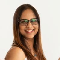 smiling woman with dark brown hair and glasses