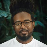 Black man with locks and glasses