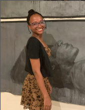 headshot in front of painting at opening night at the Olympia gallery